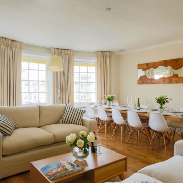 Living room and dining area in the sea view penthouse maisonette